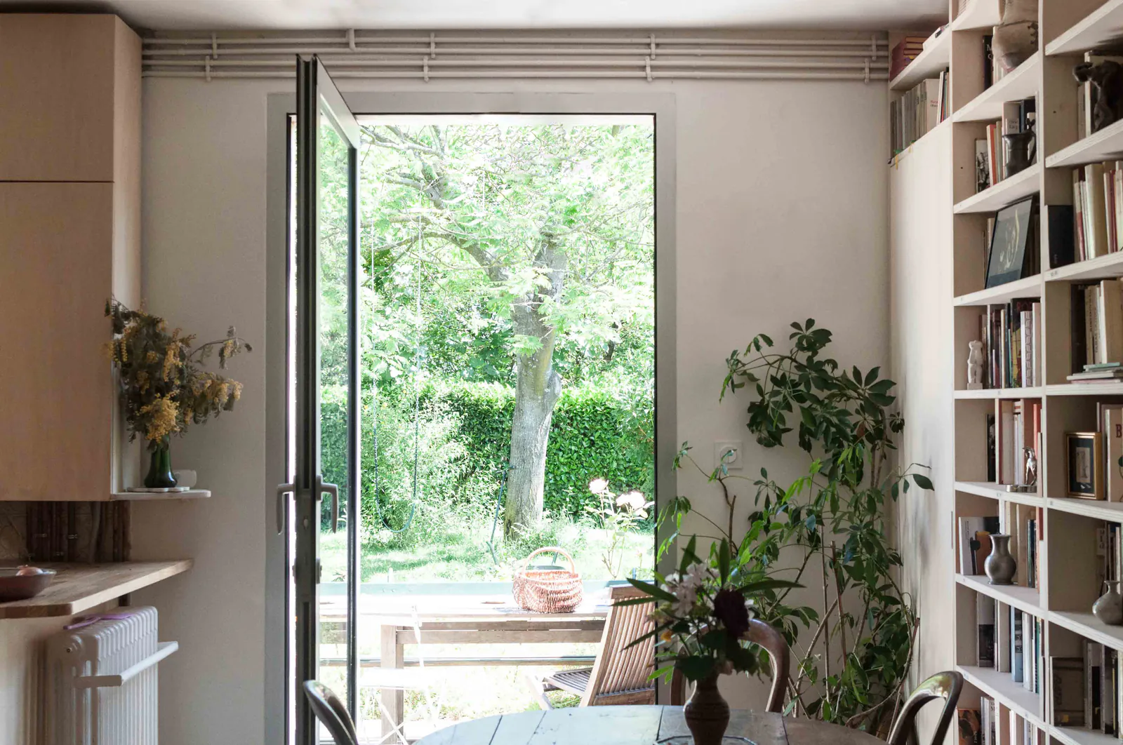 Nîmes — Porte-fenêtre ouverte sur le jardin, plantes et bibliothèque
